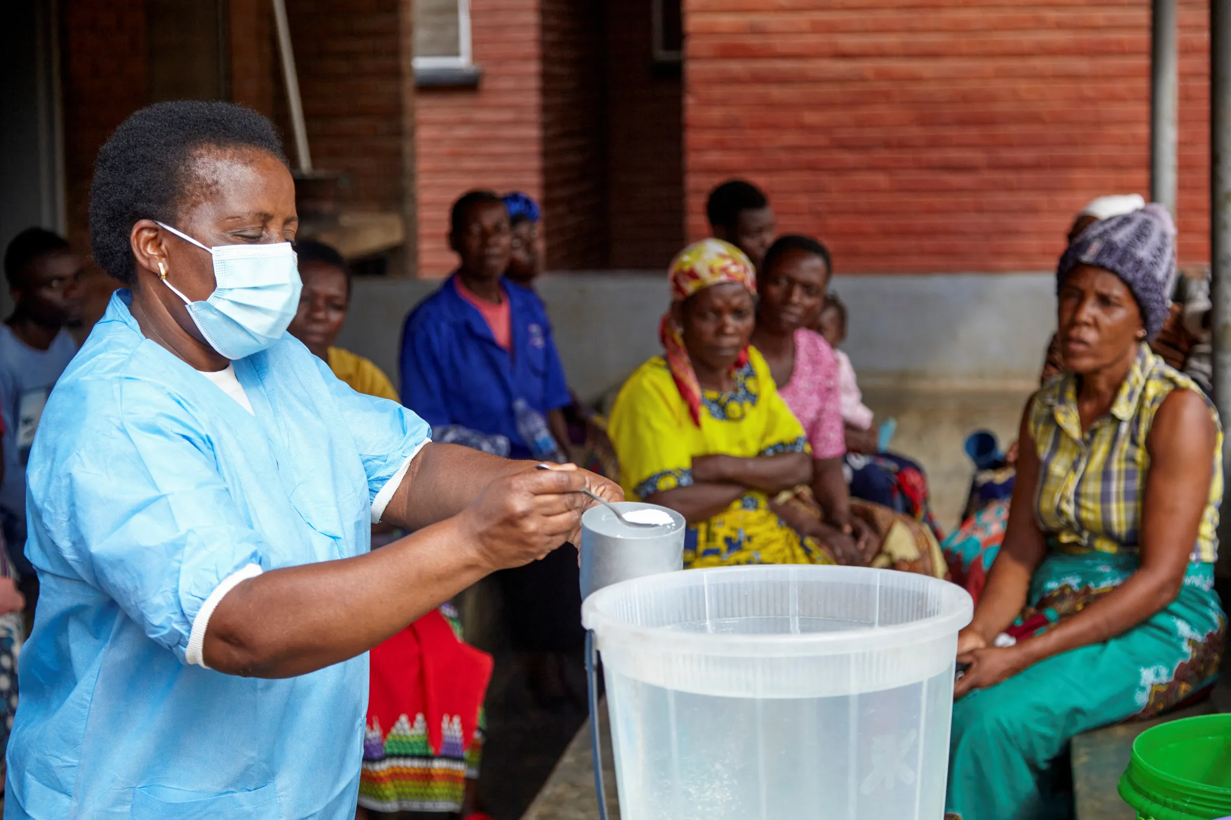 A health surveillance assistant mixes chlorine with water to disinfect it at a health centre in response to the latest cholera outbreak in Blantyre, Malawi, November 16, 2022. REUTERS/Eldson Chagara