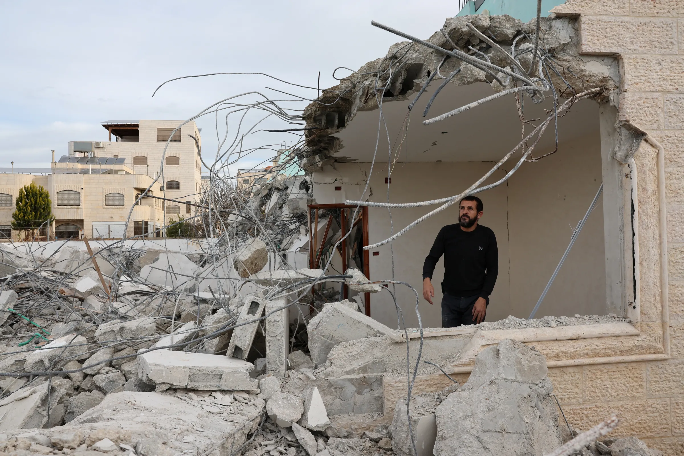 A person checks the damage after the Israeli army demolished a house of Palestinian assailant, in Hebron in the Israeli-occupied West Bank January 21, 2024. REUTERS/Mussa Qawasma